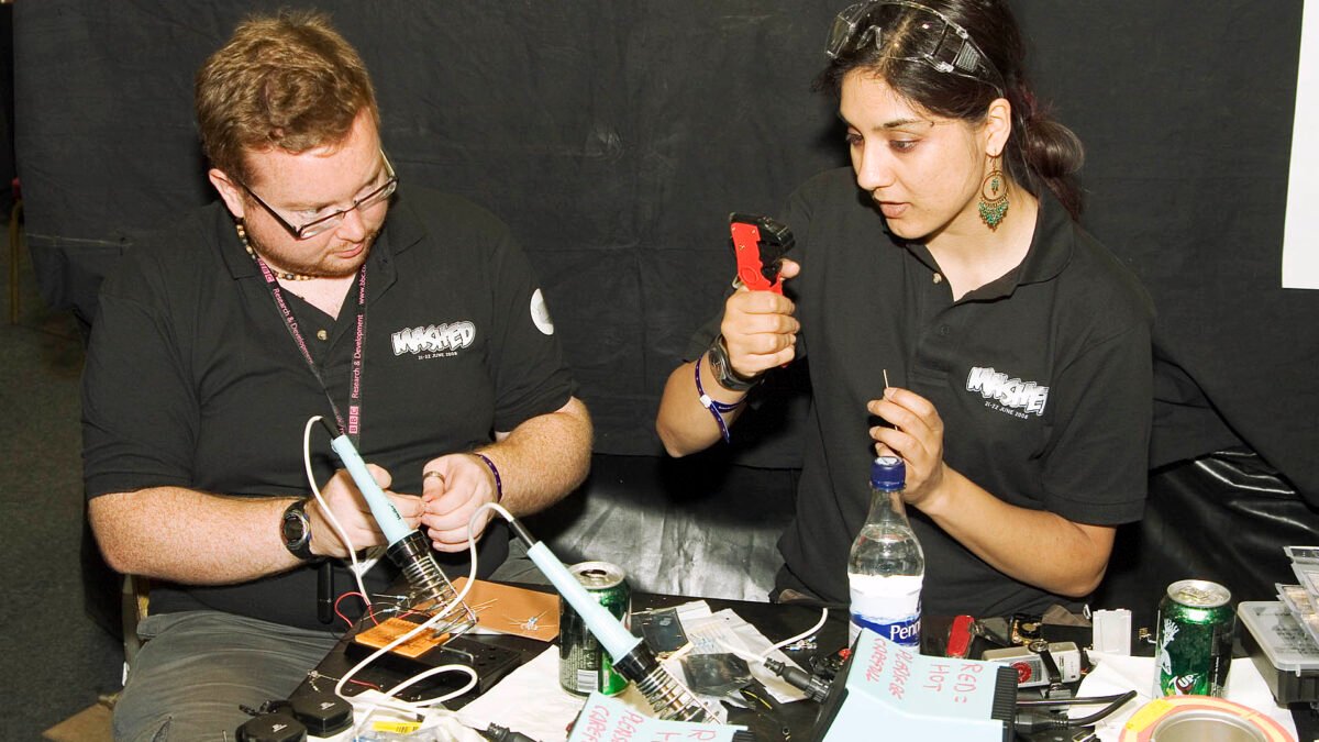 Engineers soldering electronics